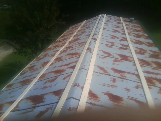 Rusted metal roof panels with new wood purlins before replacement — Storm Damage Roof Repair in Mountain Home by Roofing Brothers